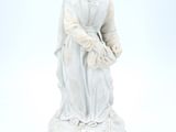 a statue of a woman sitting on a pedestal