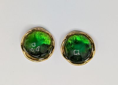 pair of green glass stud earrings with gold accents on a white surface