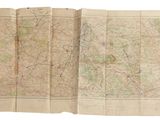 an old map of the world is open on a white surface