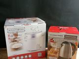 two boxes of kitchen appliances sitting on a table next to each other