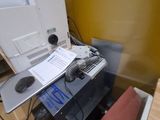 a desk with a computer and a printer on top of it