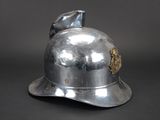 a silver helmet with a gold emblem on it