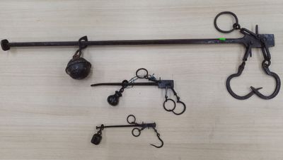 a pair of scissors and a pair of hooks on a table