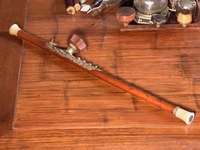 a wooden stick with a handle on a wooden table