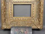 an old picture frame with a picture of a man and a woman