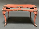 an orange painted desk with two drawers and a drawer on top of it