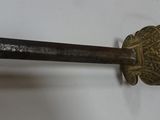 a close up of a sword on a wall