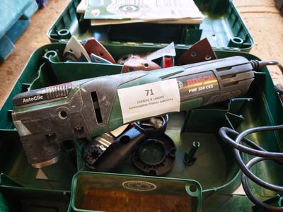 a green box filled with assorted tools on the floor