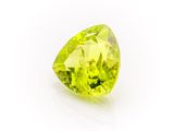 a close up of a yellow diamond on a white surface