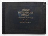 an old book with a black cover sitting on top of a table