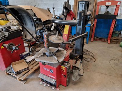 a machine that is sitting in a garage with a lot of tools