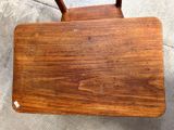 a wooden chair that has a wooden seat on it