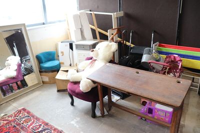 a teddy bear that is sitting on a chair in a room