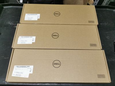 three dell laptops are stacked on top of each other on a table