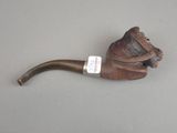 a pipe that is sitting on a table with a tag on it