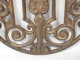 a decorative iron wall hanging on a white wall