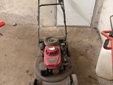une tondeuse à gazon qui traîne dans un garage
