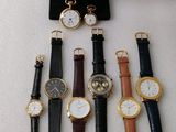 several different types of watches are displayed on a display stand