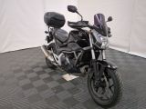 a motorcycle that is parked on a black and white checkered floor