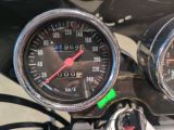 two gauges on the handlebars of a motorcycle