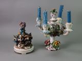 two figurines sitting next to each other on a table