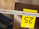 a measuring tape that is on top of a wooden table