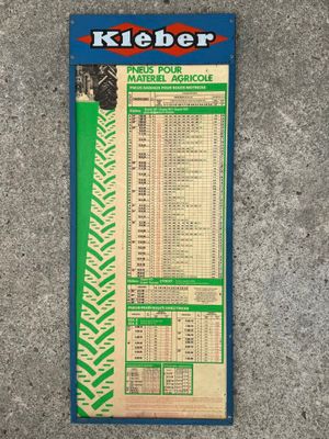 a close up of a sign on the ground with a price list on it