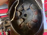 a hand that is holding a metal object on a table