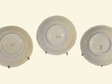 three white plates sitting on top of each other