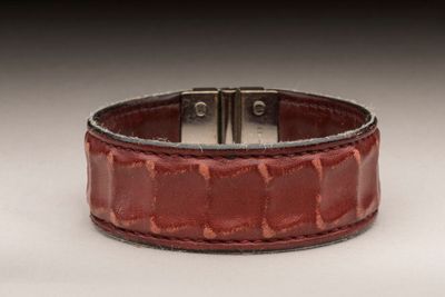 HERMES - BRACELET manchette en cuir embossé bordeaux, le fer…