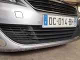a silver car parked in a garage with a number plate on the front