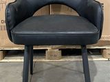 a black chair that is sitting in front of some boxes