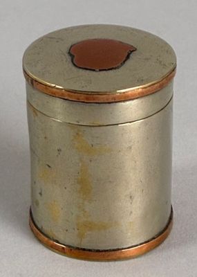 a small silver box with a brown lid