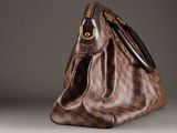 louis vuitton damier bag on a grey background
