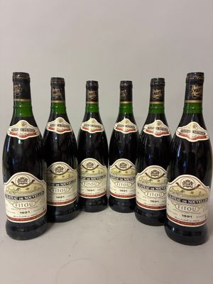 six bottles of wine are lined up in a row on a table