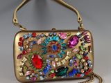 an image of a gold purse with colorful jewels on it