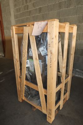 a wooden crate with a bag of garbage inside of it