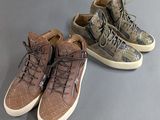 two pairs of shoes are lined up on a gray surface