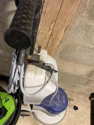 a green and black vacuum cleaner and a green and white mop