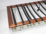 a wooden shelf with black strips on top of it