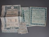 several old paper currency are displayed on a gray surface