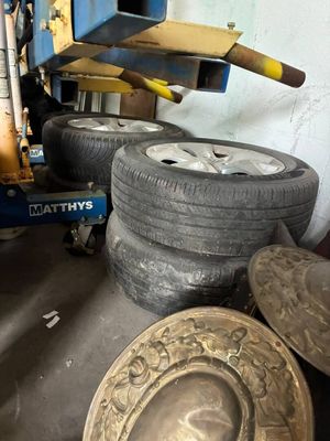 a pile of tires sitting on the floor next to a machine