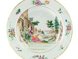 a plate with a painting on it on a white surface