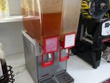a beverage dispenser sitting on a counter in a store