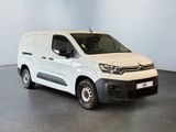 a white van parked in a room with a black floor