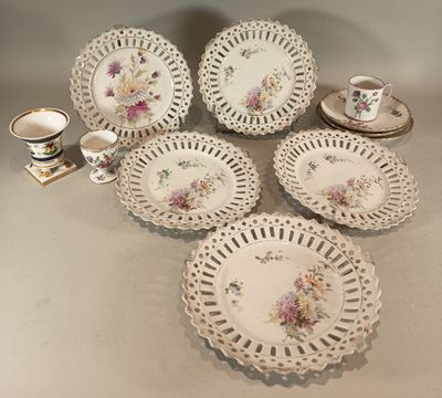 several plates and cups on a table with a cup and saucer