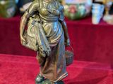 a statue of a woman holding a basket on a table