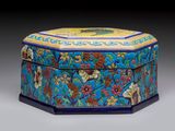 une boîte bleue et jaune décorée de fleurs et de feuilles