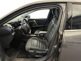 the interior of a car with the door open showing the driver ' s seat