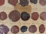 a lot of wax seals that are on a piece of paper